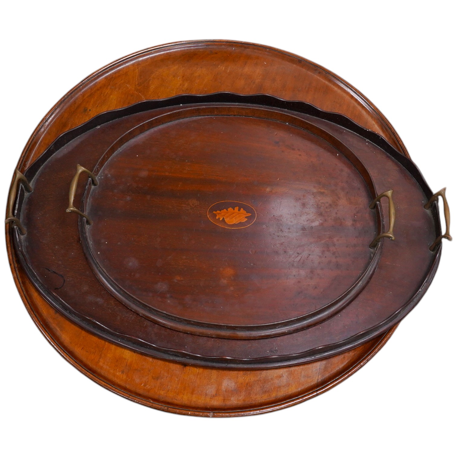 Three various mahogany trays including an Edwardian inlaid and galleried example, largest 61cm wide. Condition - fair